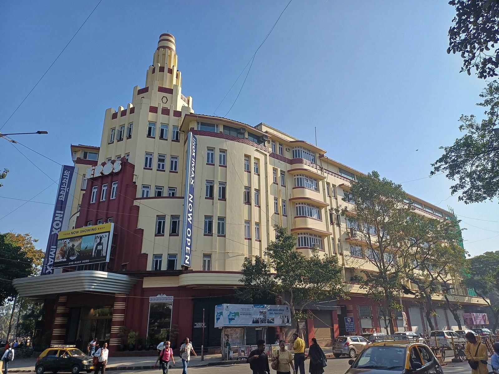 The Eros Cinema in Mumbai, a cream and maroon Art Deco building with a stepped ziggurat tower