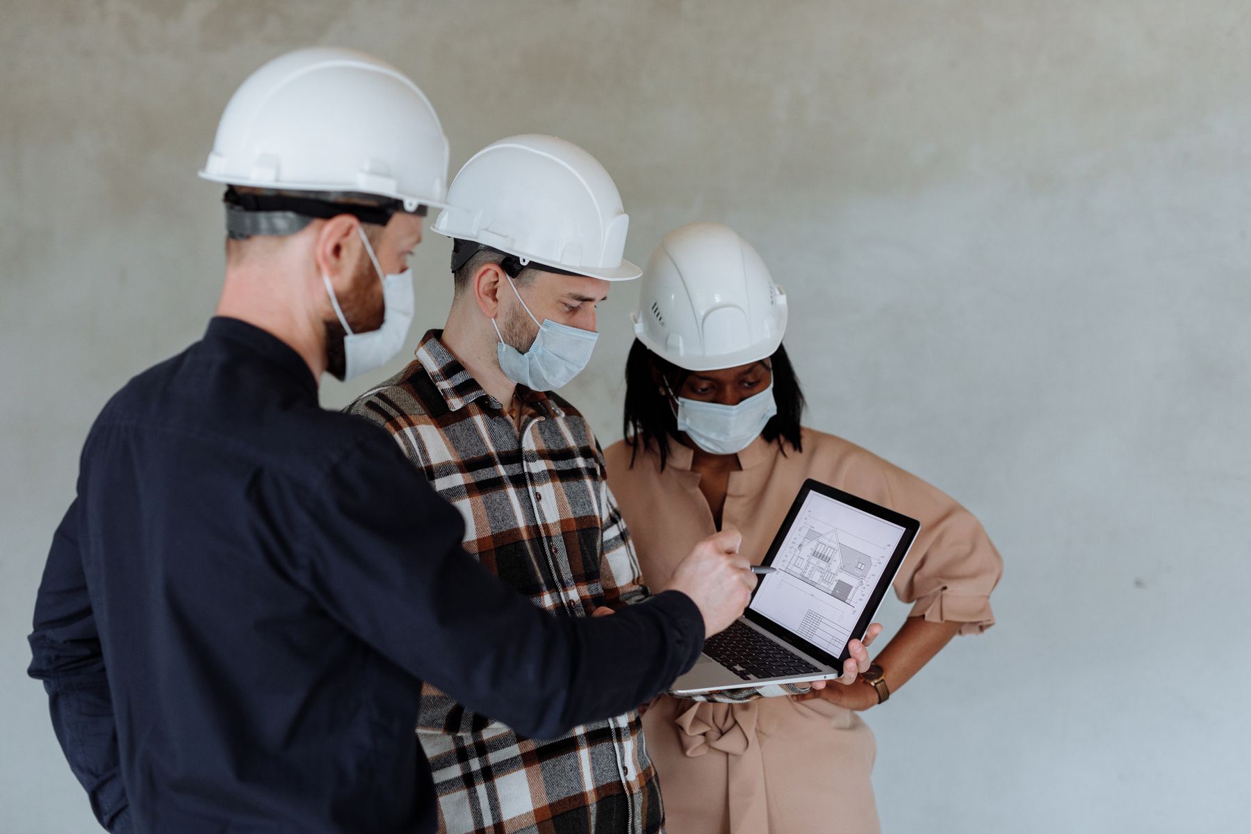 Architecture and construction team coordinating a drawing on a laptop