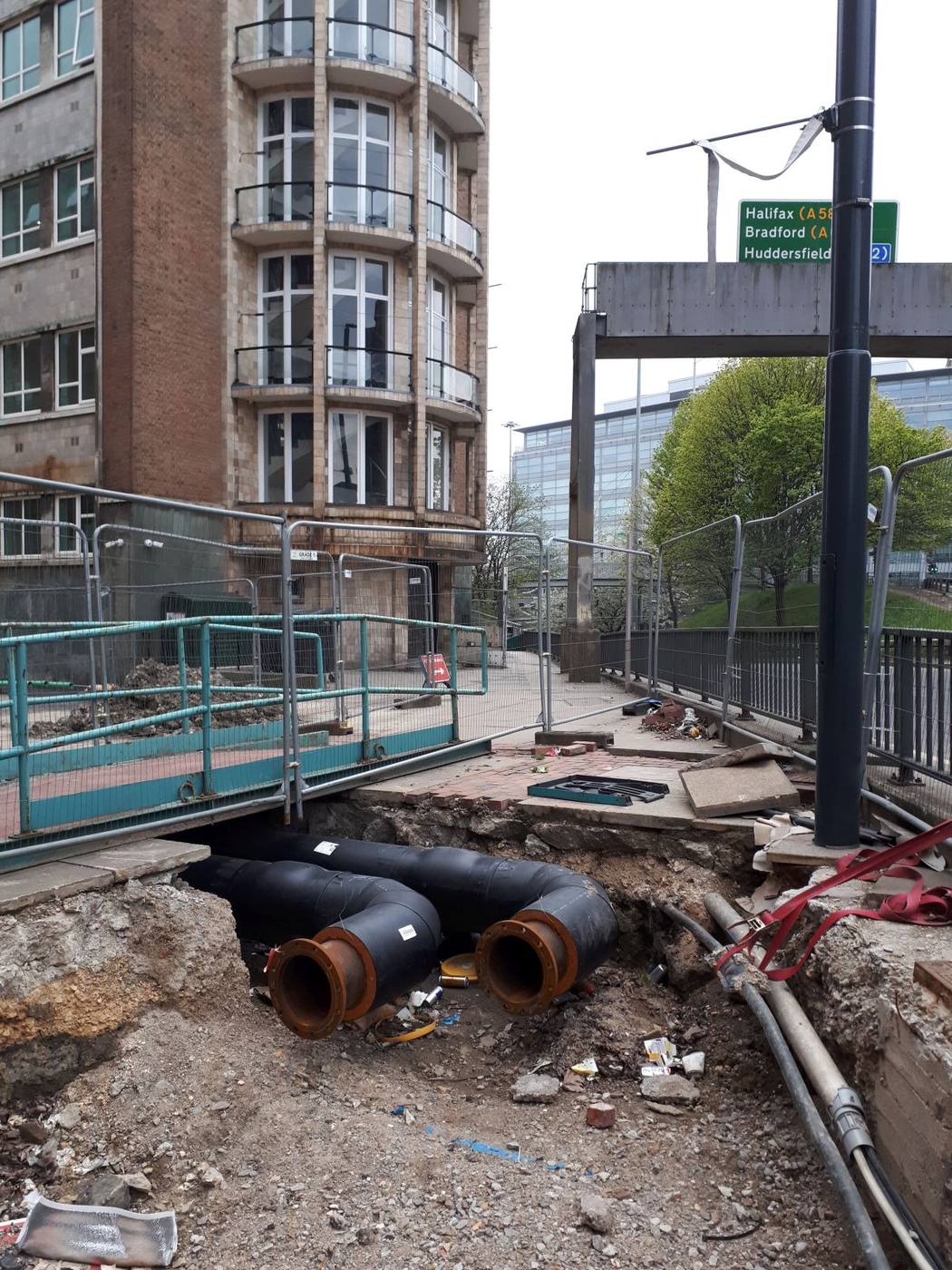 District-heating pipework carrying hot water through an urban site