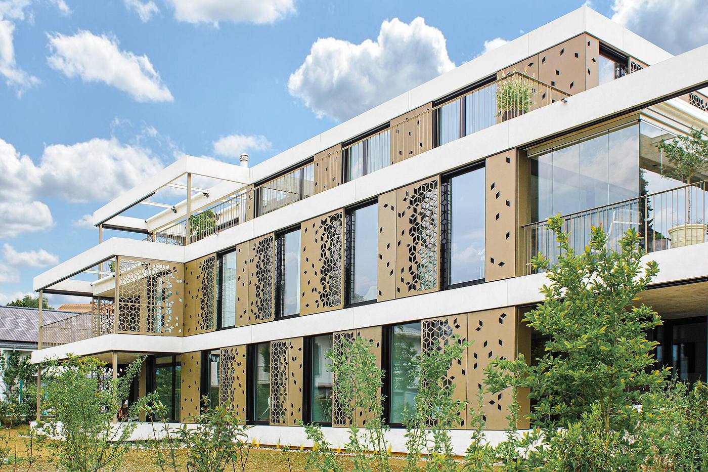 A building facade of perforated metal shading and screening panels