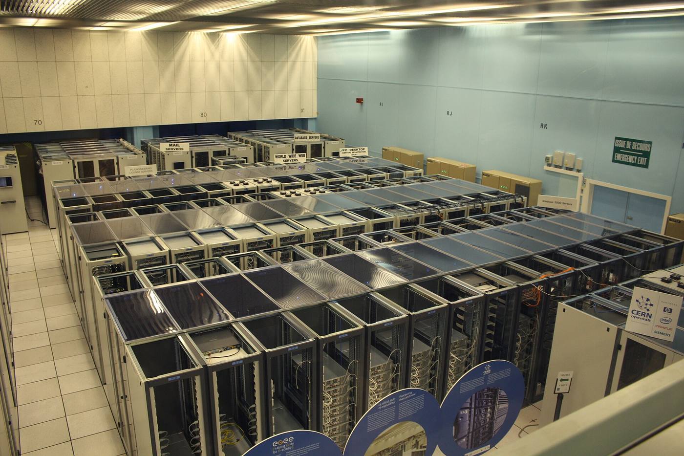 Rows of server racks forming long corridors inside a computer hall