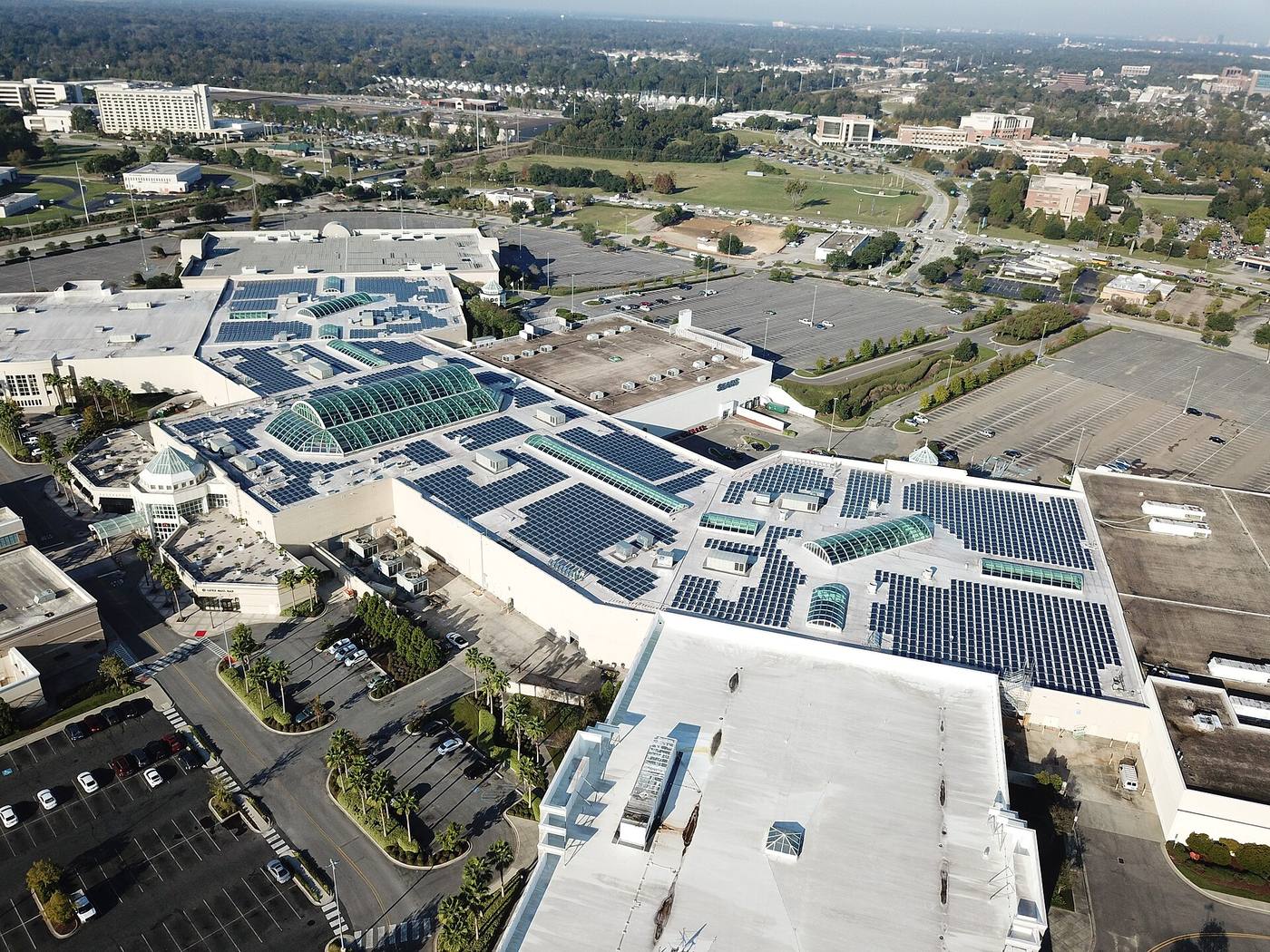 A vast flat industrial roof covered in solar photovoltaic panels