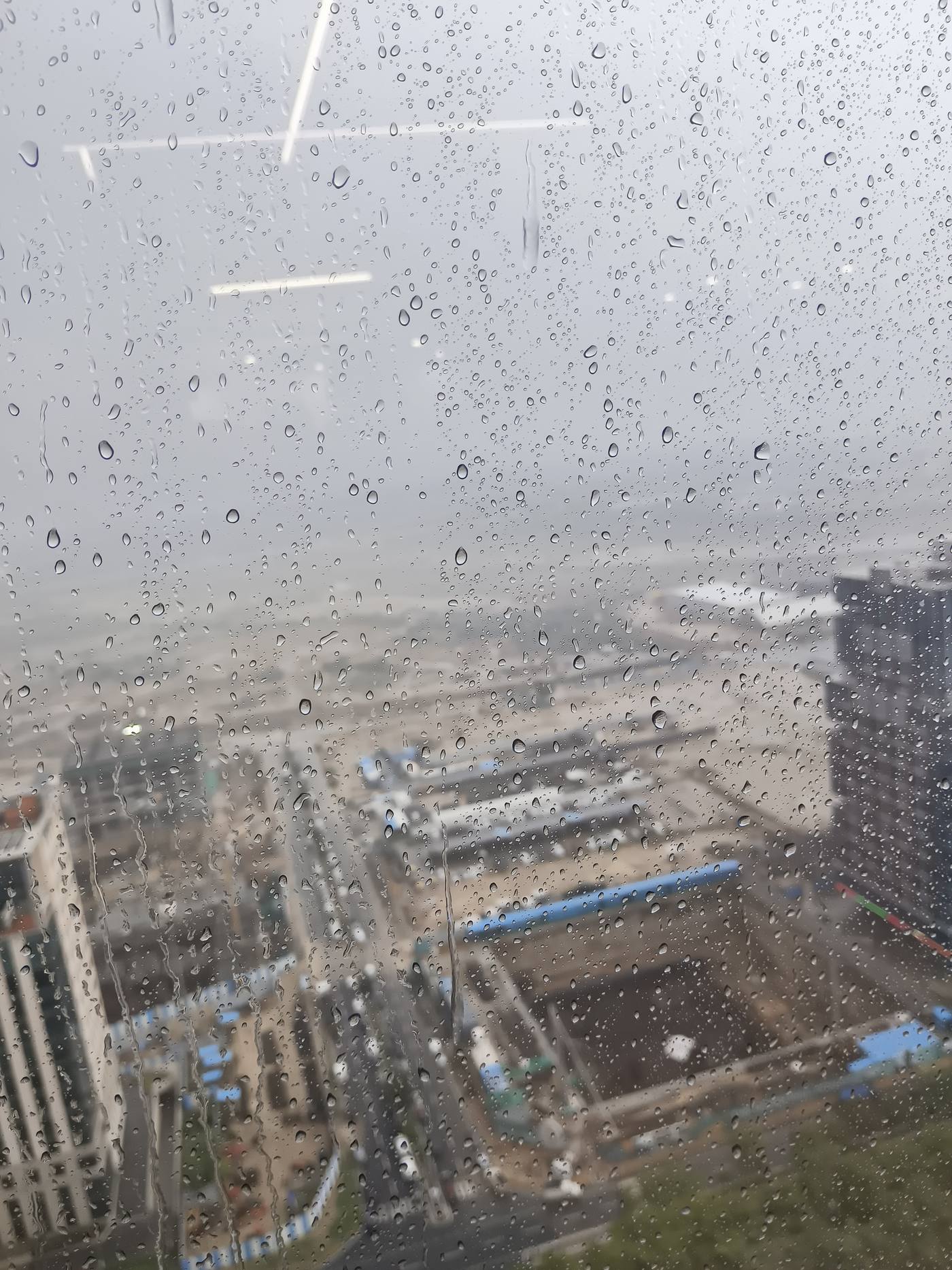 Condensation droplets on a window obscuring the view outside