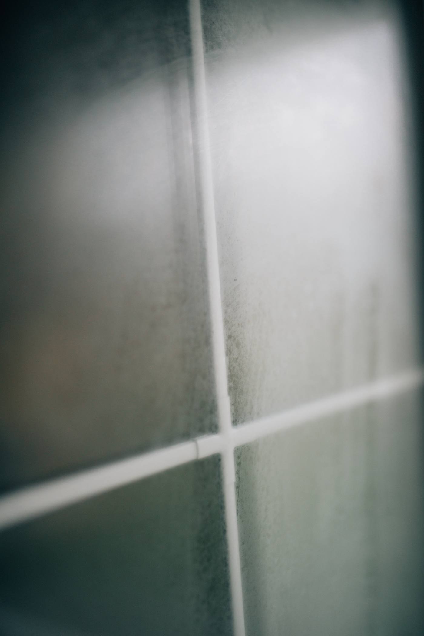 Close-up of condensation droplets on glass — warm moist air meeting a cold surface