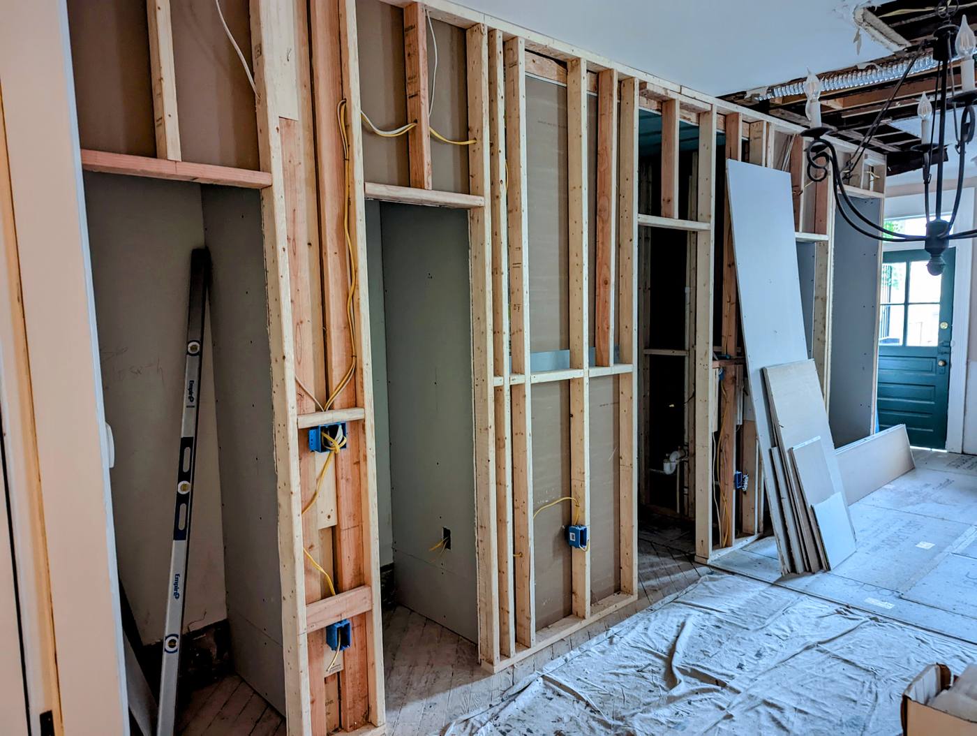 Exposed timber stud wall framing with vertical wooden studs during a home renovation