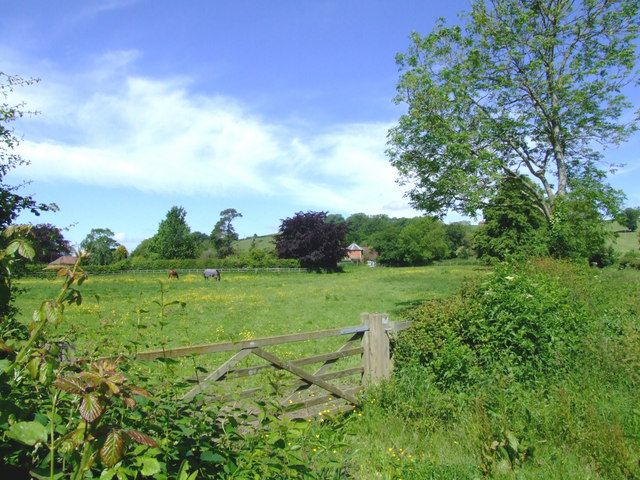 A stone manor house at Ditcheat with a brick perimeter wall, traditional masonry construction