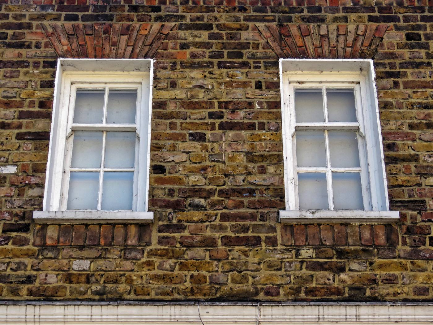 Upper-storey sash windows in brickwork in Tottenham, London