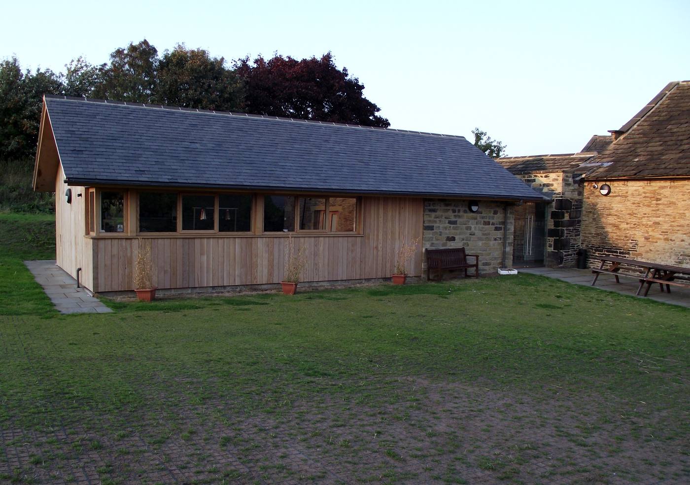 Timber-clad rear kitchen extension added to a stone building at Northorpe Hall