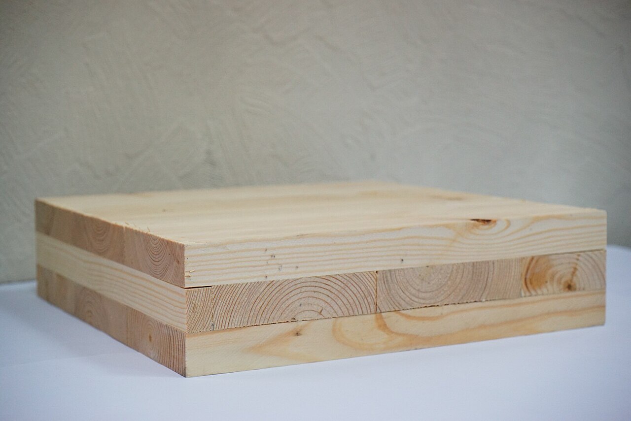Close view of a three-layer cross-laminated timber panel showing alternating board directions