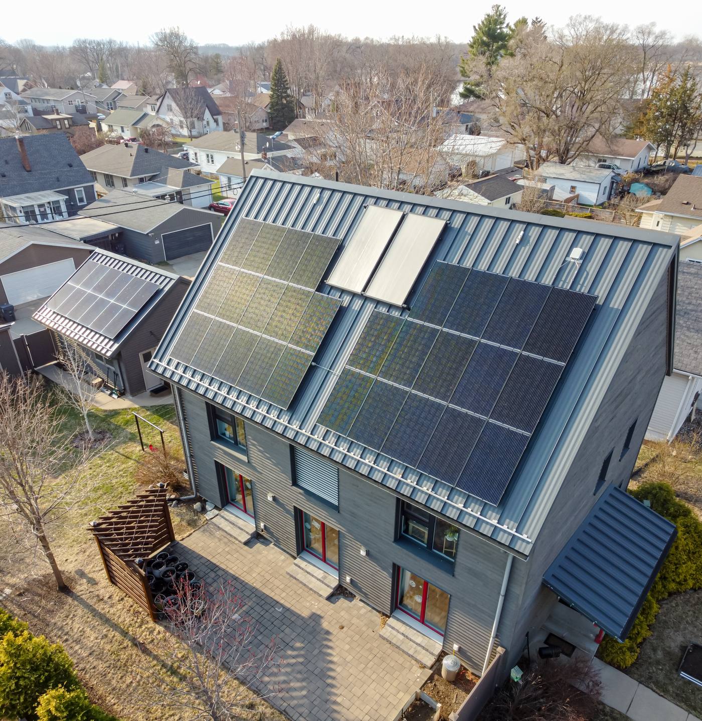 An aerial view of a modern passive house with solar panels in La Crosse