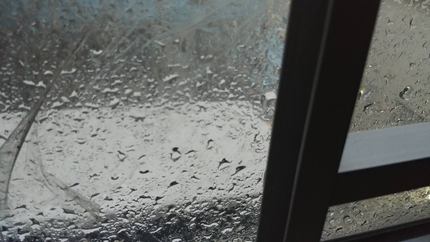 Water droplets on window glass — the visible sign of excess indoor moisture