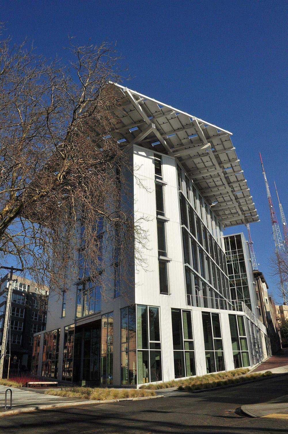 Bullitt Center in Seattle with a large photovoltaic roof canopy extending beyond the facade