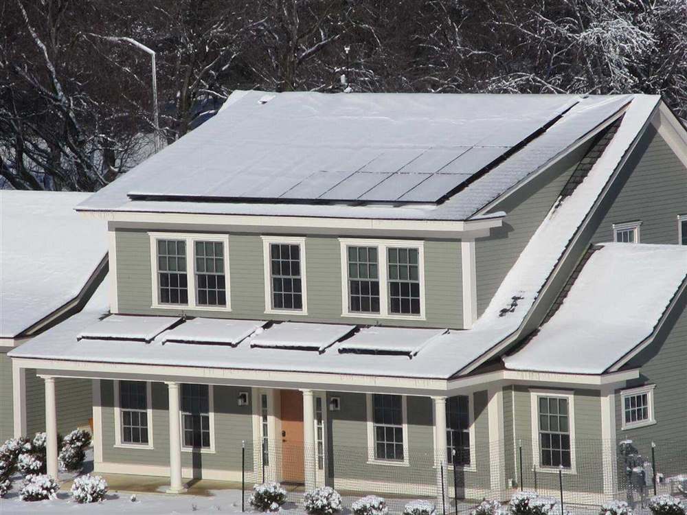 NIST Net-Zero Energy Residential Test Facility in winter with photovoltaic and solar thermal panels on the roof