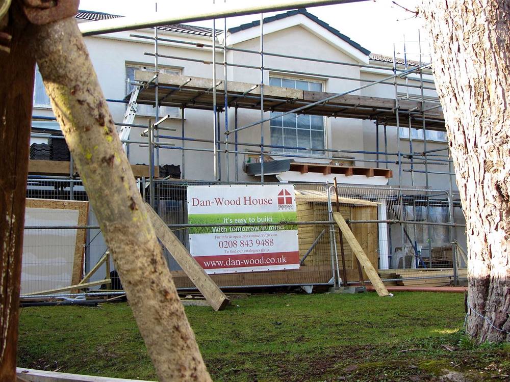 Timber prefabricated house under construction in north London with factory-made wall and roof elements