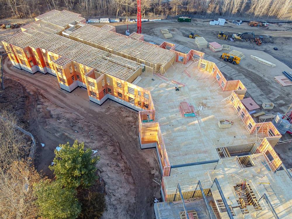 Aerial view of prefabricated building frames and tower cranes on a construction site in Wisconsin
