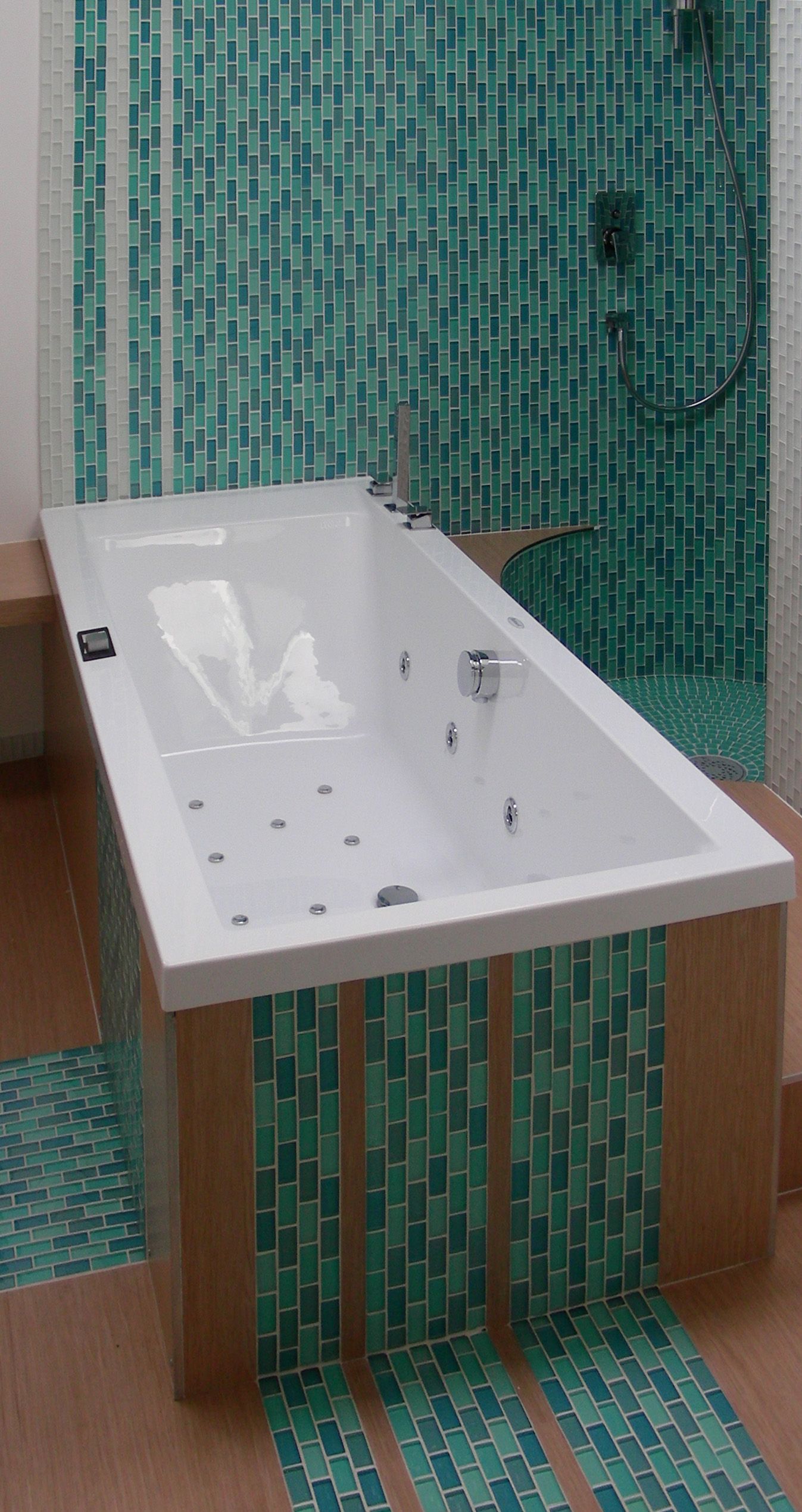 A rounded shower enclosure tucked into the room — the corner layout's space-saving move