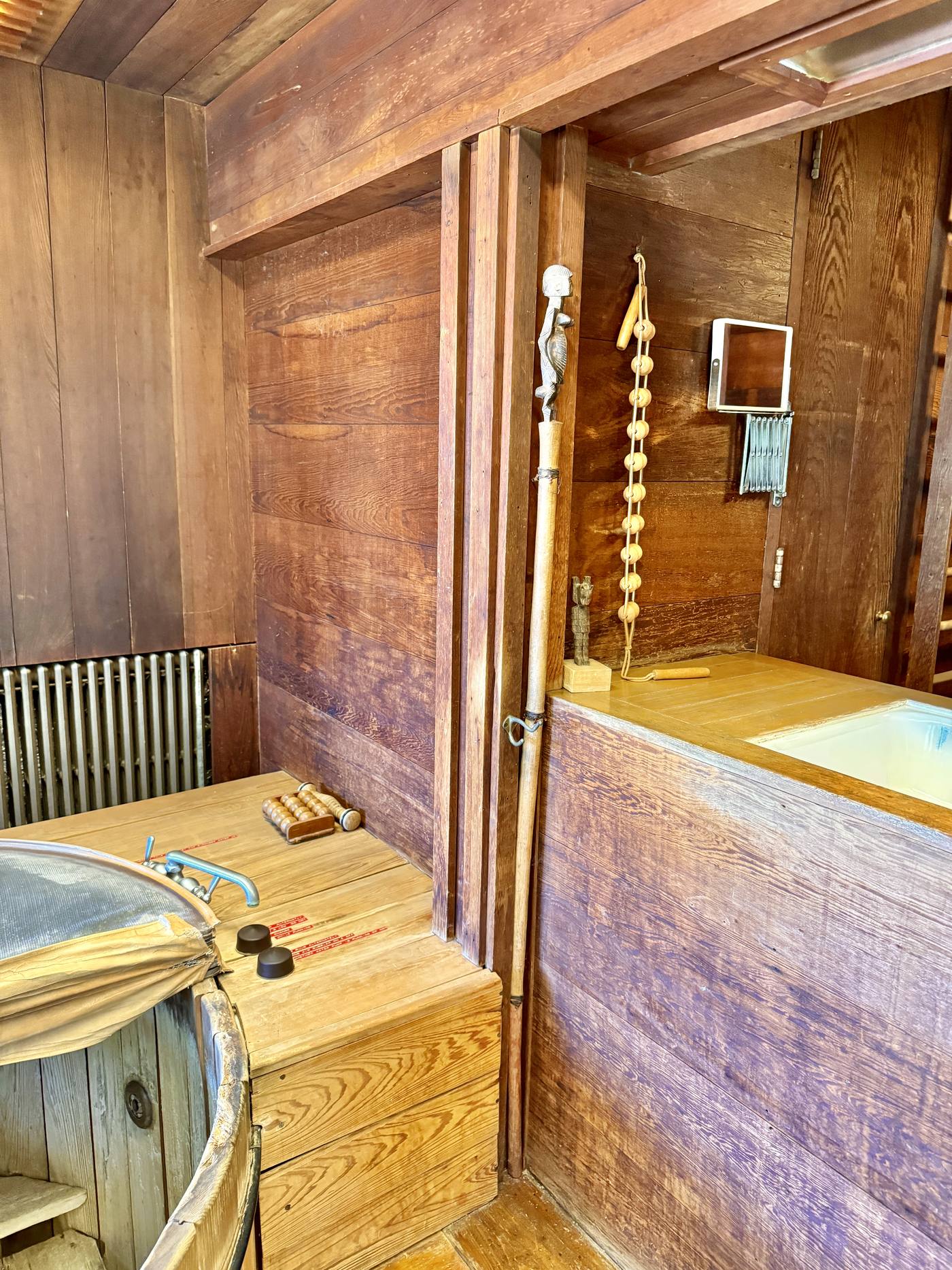 A modern bathroom with a cypress wood tub and shower at the Paul Schweiker House and Studio
