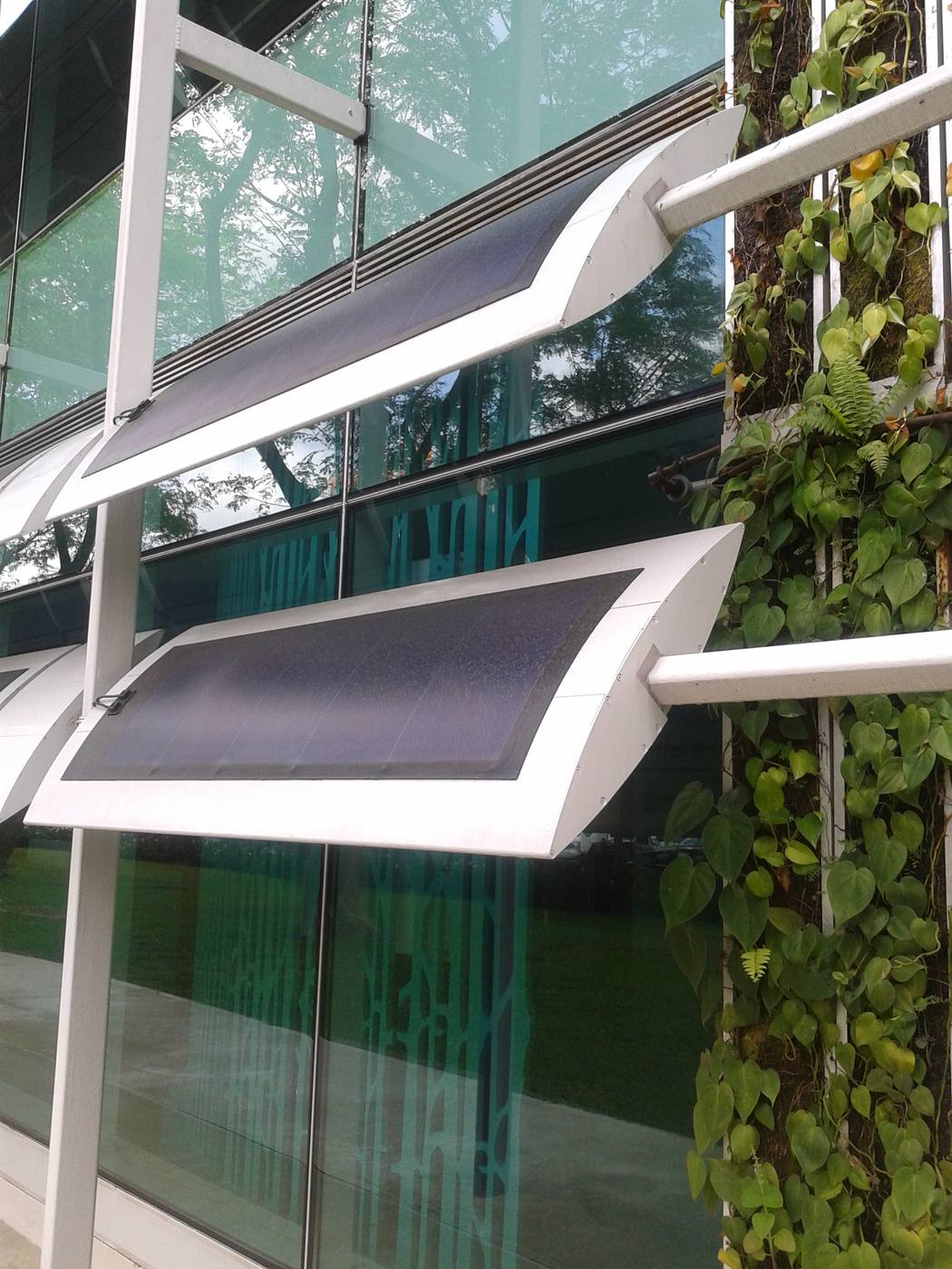 Photovoltaic panels used as external shading fins on a zero-energy building in Singapore