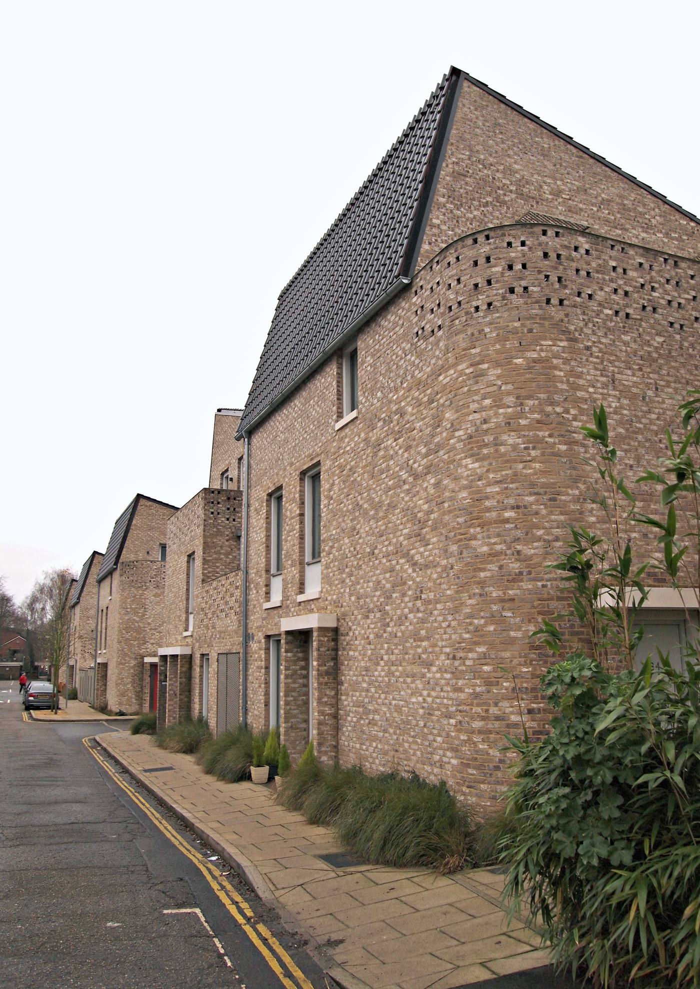 Brick terraces of the Goldsmith Street council housing scheme in Norwich, seen along the street