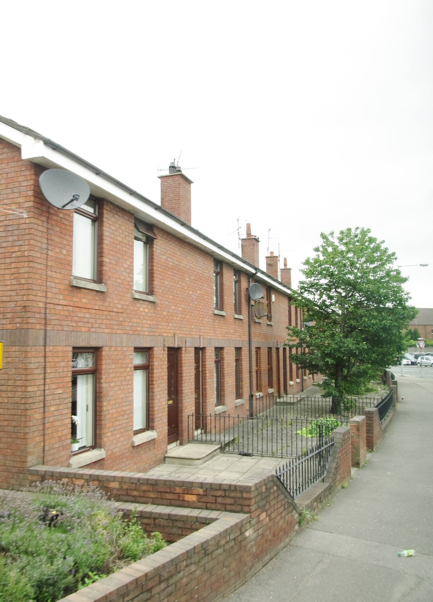 Row of modern brick-built terraced houses on a UK street