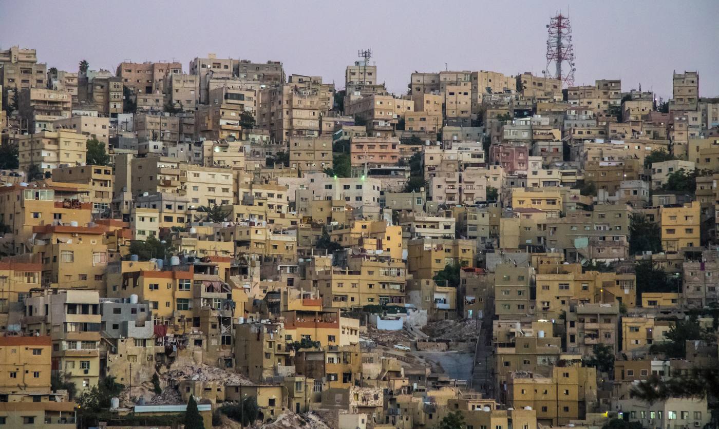 Amman’s hillside limestone cityscape at dusk