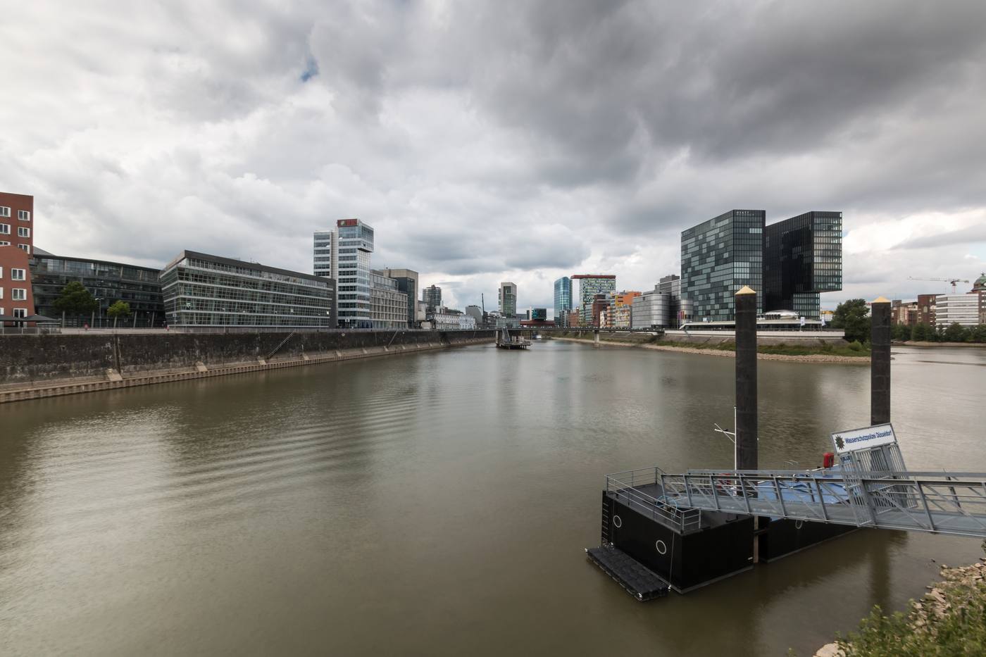 The Medienhafen harbour basin in Düsseldorf, with modern harbour buildings across the water