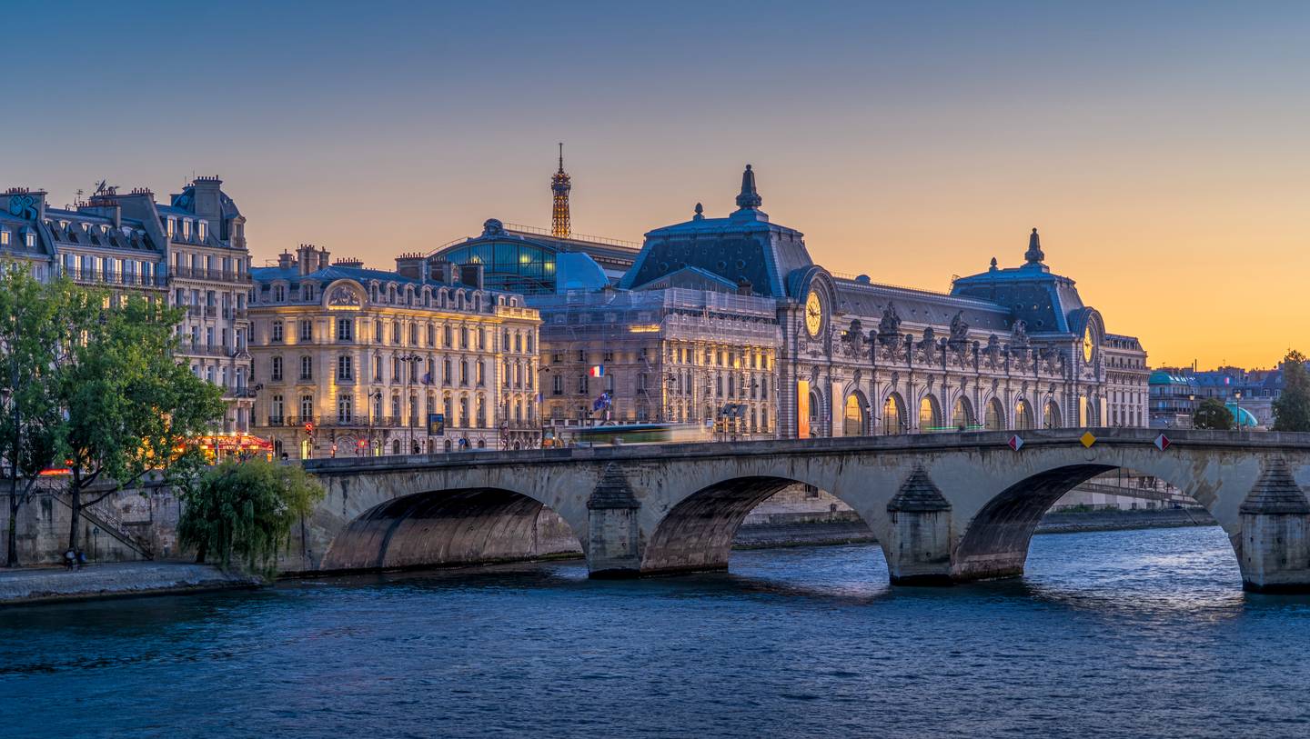 The Musée d’Orsay beside the Seine in Paris at dusk, seen from the Pont Royal