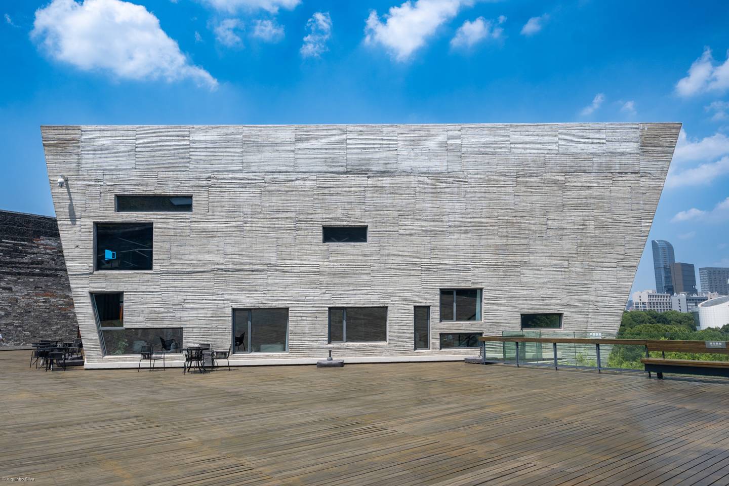 The Ningbo Museum in China, its sloped facade of recycled tiles and bricks above a timber terrace