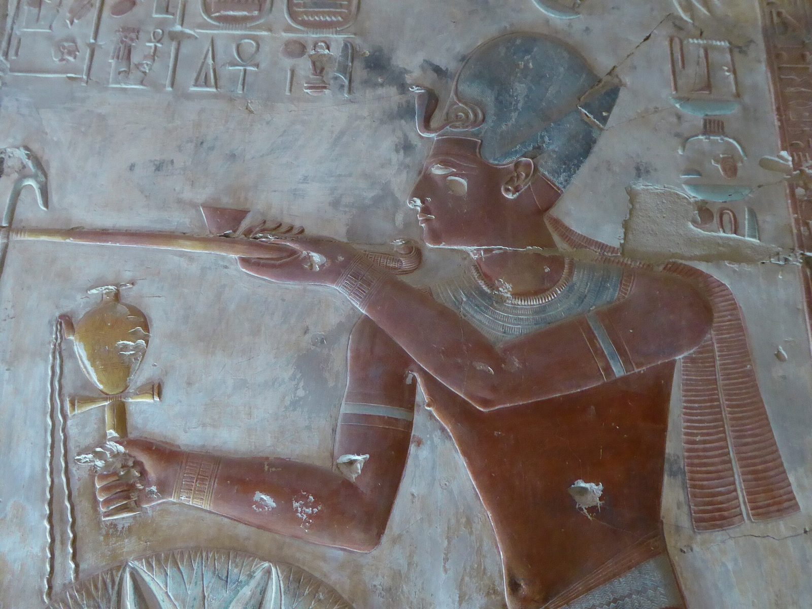 Painted raised relief in the Temple of Seti I at Abydos: the king presenting an offering, his figure carved and coloured on the temple wall