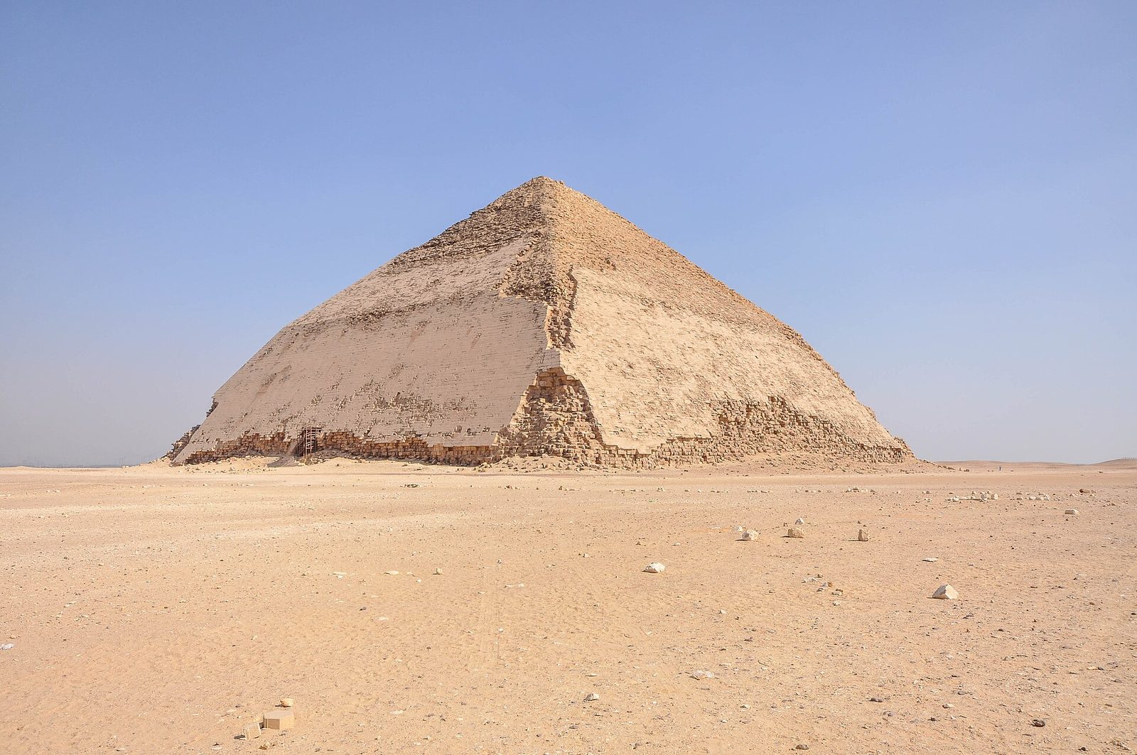 The Bent Pyramid of Sneferu at Dahshur, its smooth limestone casing surviving where the slope changes angle halfway up