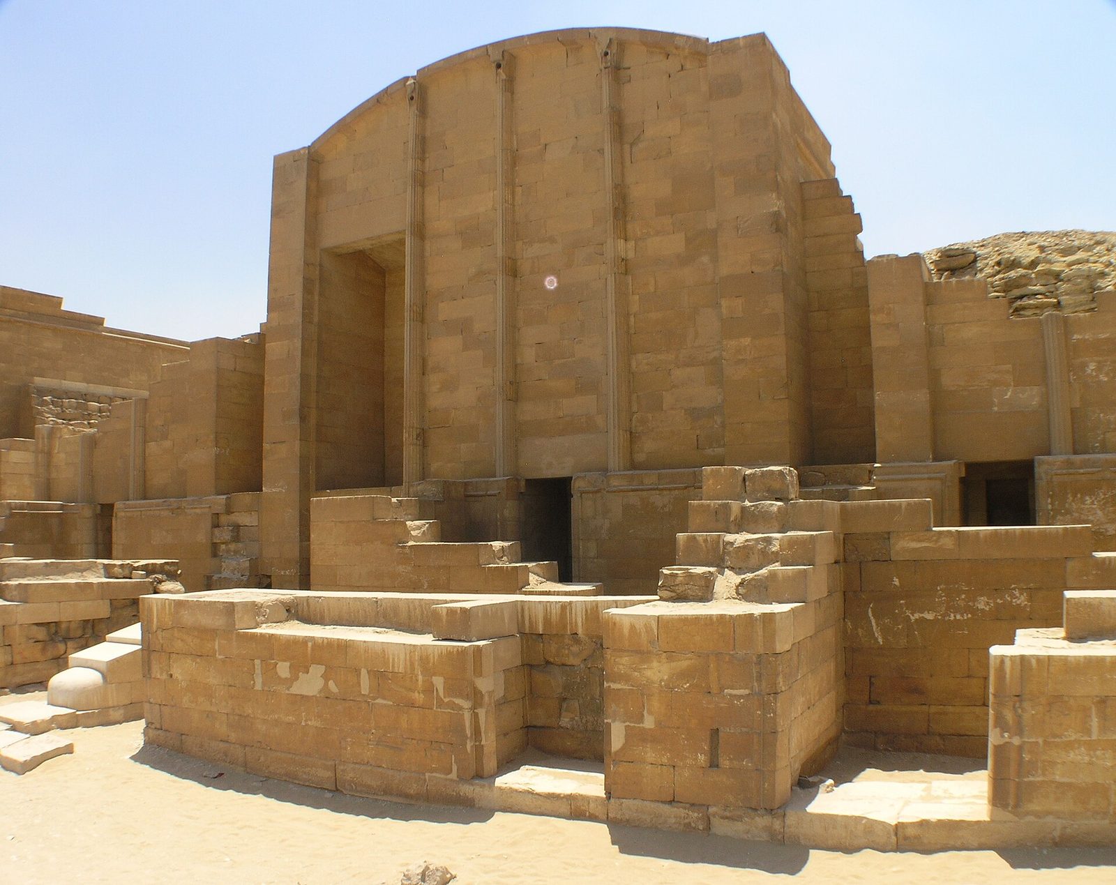 A Heb-sed court chapel in Djoser's complex at Saqqara: a stone building imitating a reed-and-timber shrine, its facade curving like a bent roof