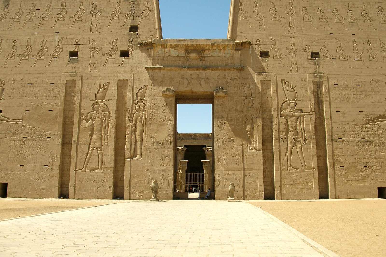 The pylon of the Temple of Horus at Edfu: two battered towers carved with the king smiting his enemies before the god