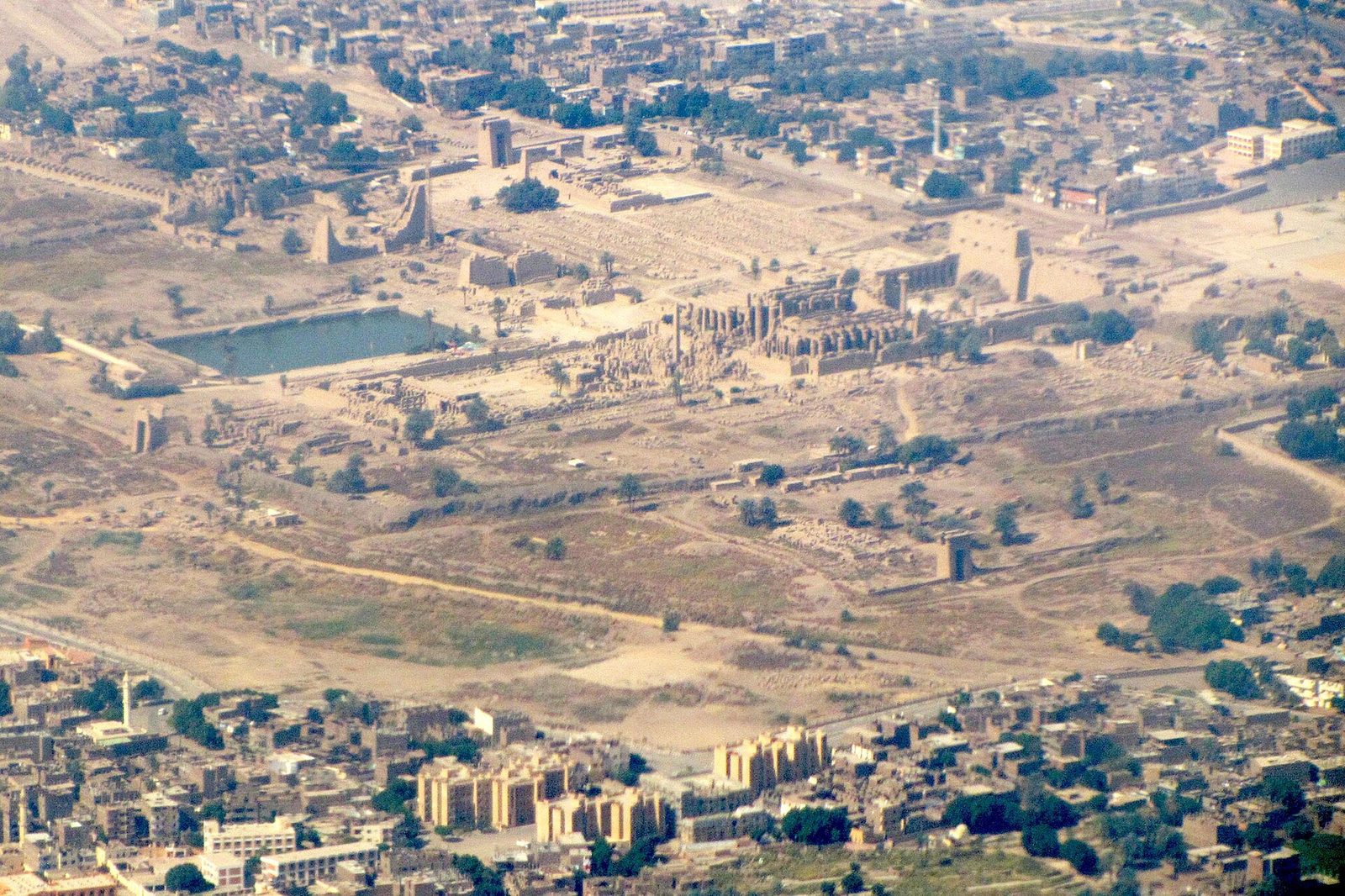 Karnak from the air: the Amun precinct's pylons, courts and sacred lake within the temple enclosure, the modern town beyond