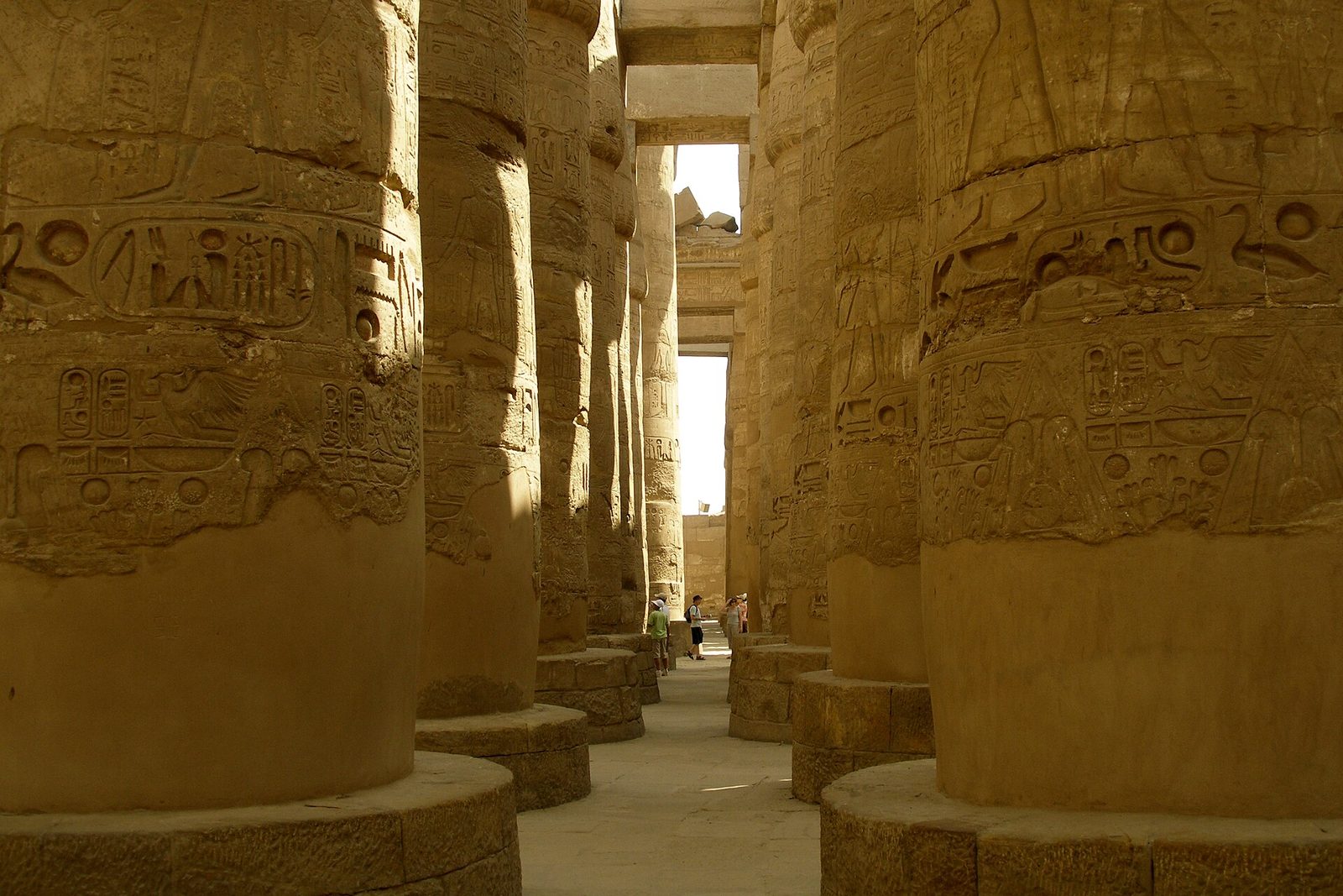 The Great Hypostyle Hall at Karnak: rows of carved columns, the central nave's papyrus capitals rising towards the clerestory light