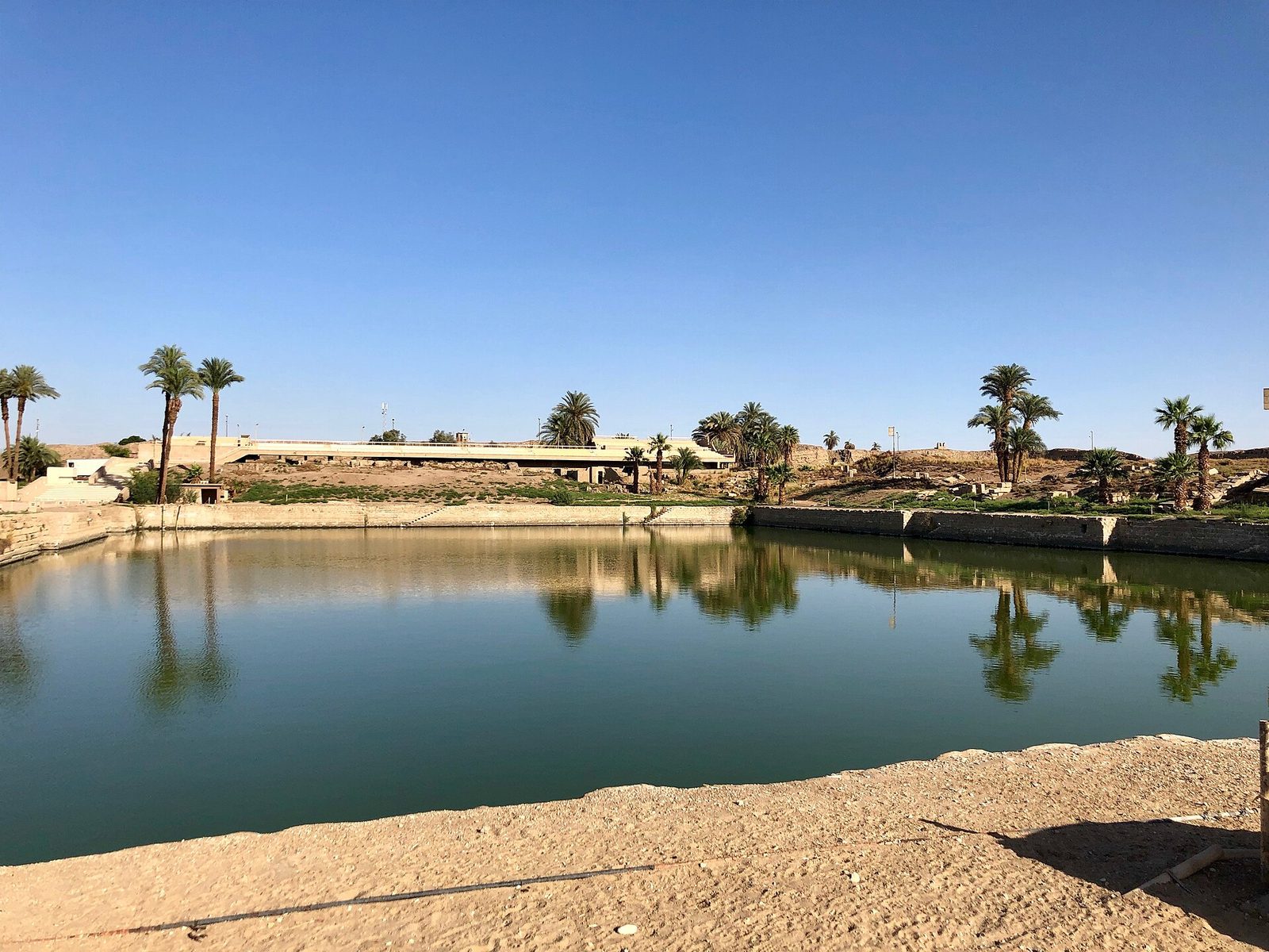The sacred lake of Karnak in daylight: the rectangular ritual pool at the heart of the Amun precinct