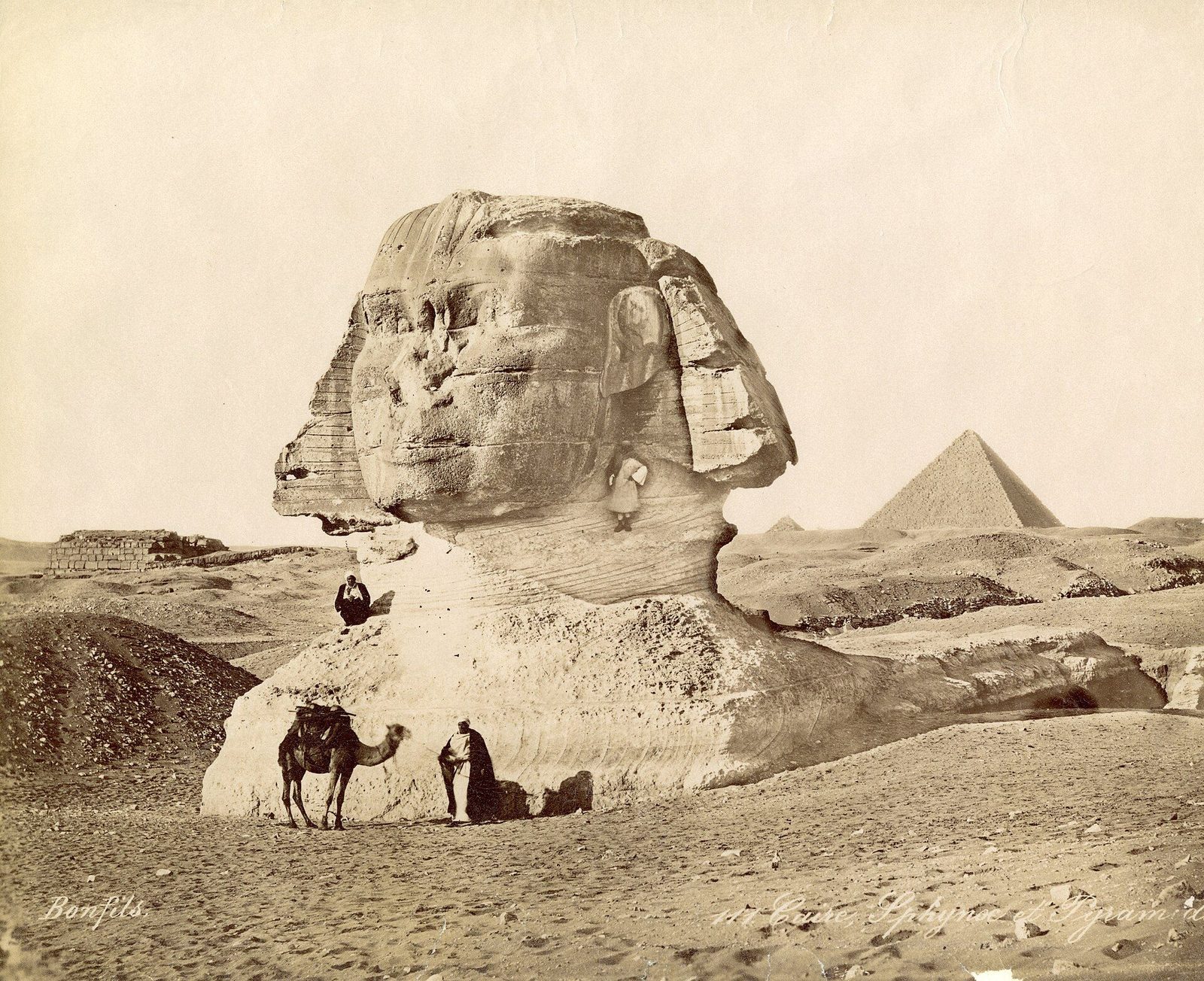 The Sphinx half-buried in sand, photographed by Félix Bonfils in the 1870s, with Khafre's pyramid behind: Giza as the nineteenth century found it
