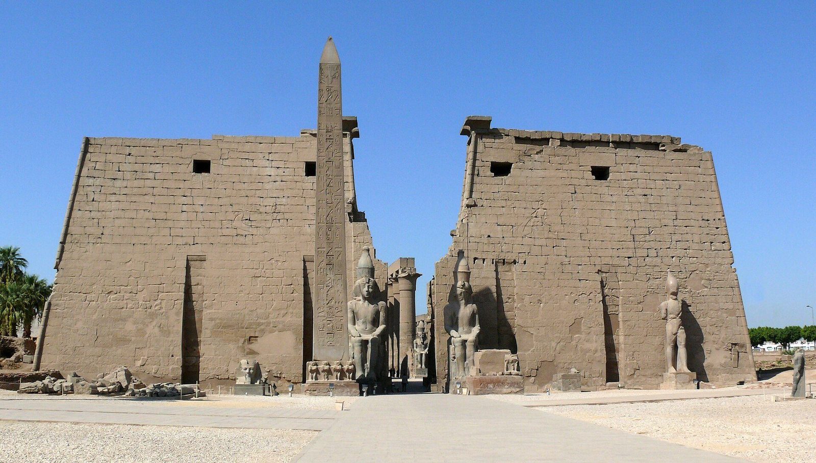The first pylon of Luxor Temple with its remaining obelisk and the seated colossi of Ramesses II before it