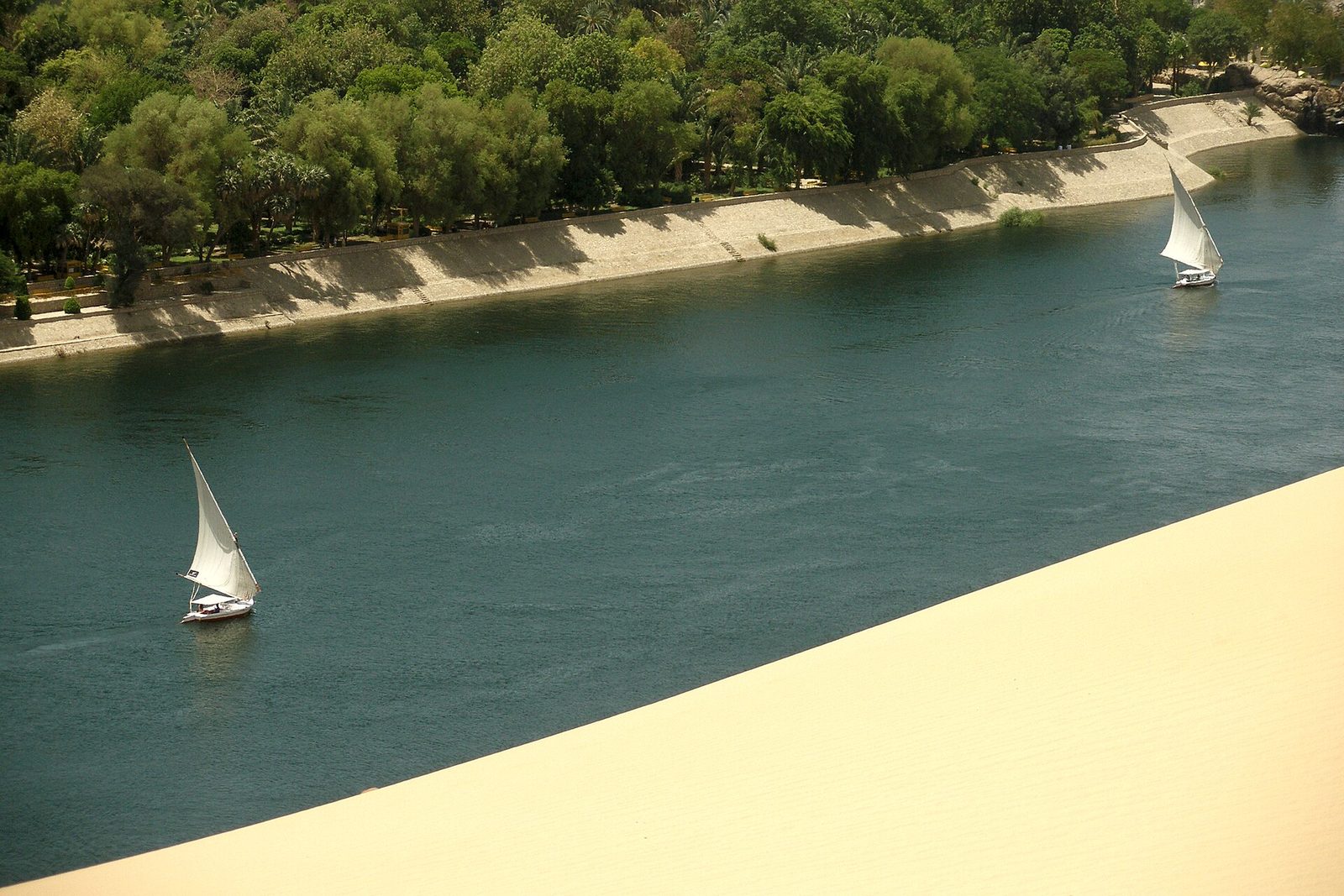 Feluccas on the Nile at Aswan: lateen-sailed boats on the river that carried Egypt's stone, grain and kings