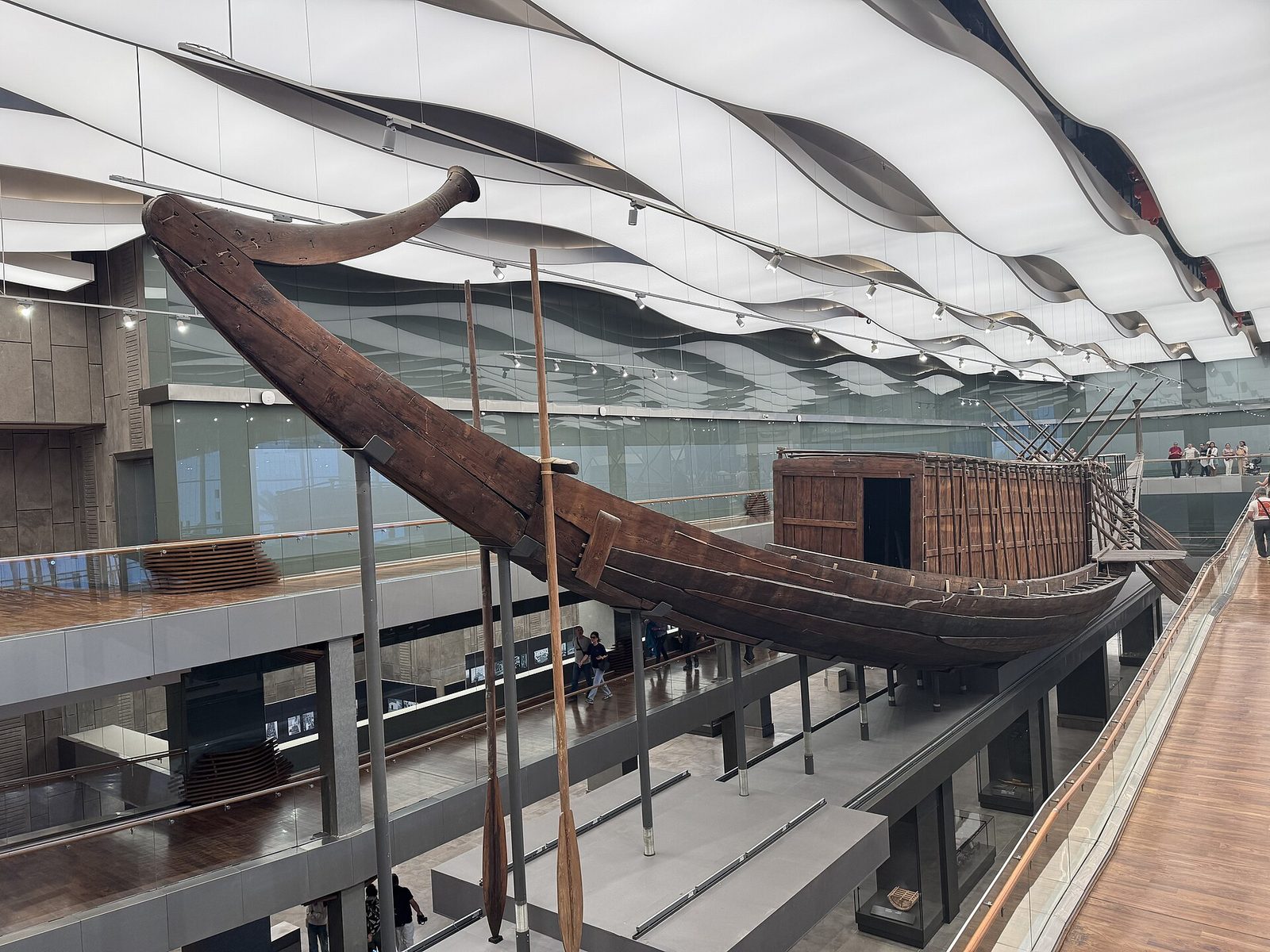 The Khufu ship in the Grand Egyptian Museum: the 43-metre cedar vessel buried beside the Great Pyramid, reassembled plank by plank