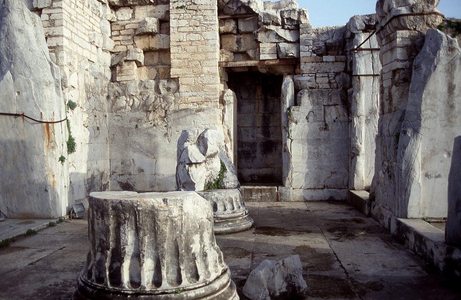 Inside the Temple of Apollo at Didyma: a fallen column drum and the doorway to the adyton