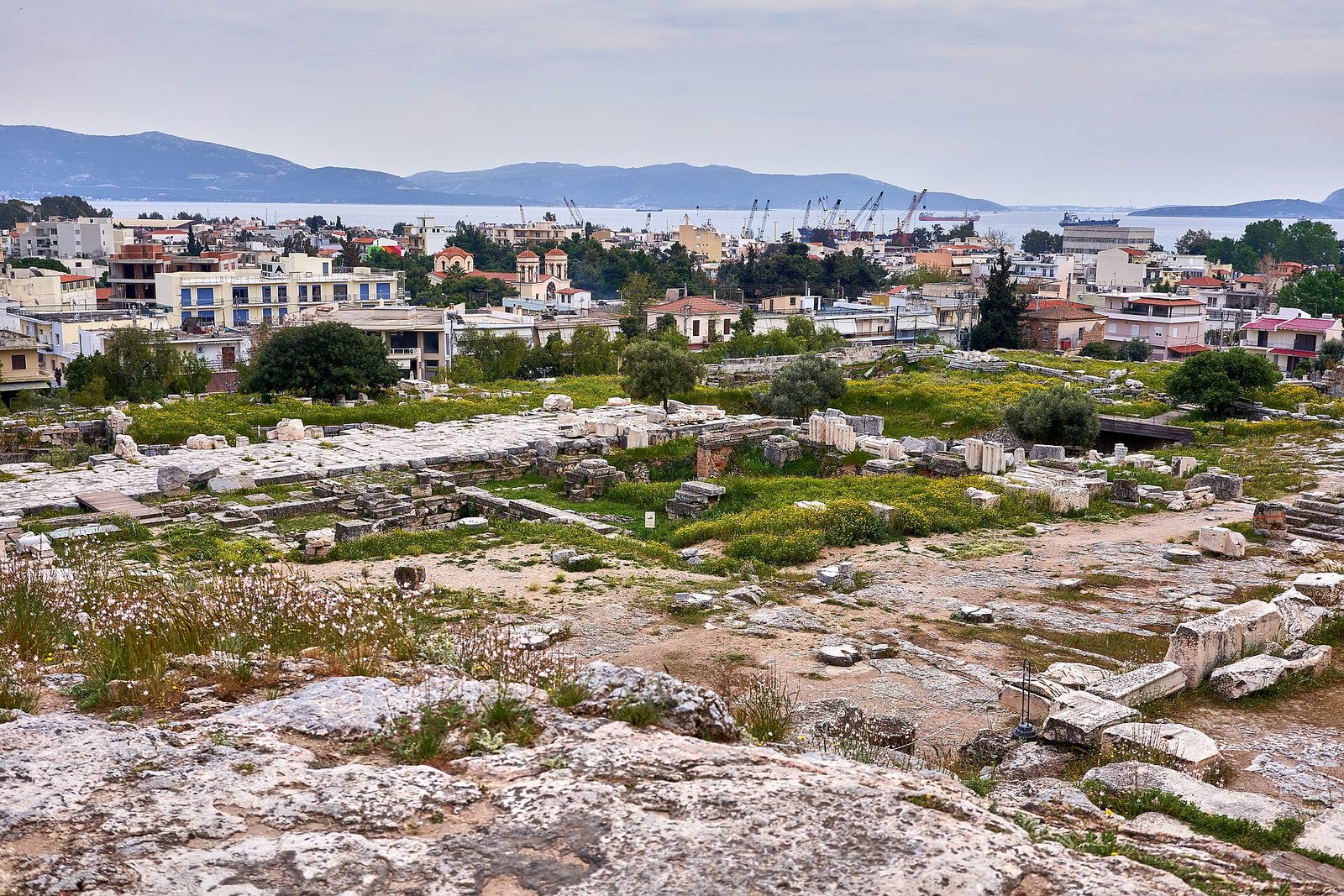 The ruins of the Telesterion at Eleusis, the hall of the Mysteries, with the modern town behind