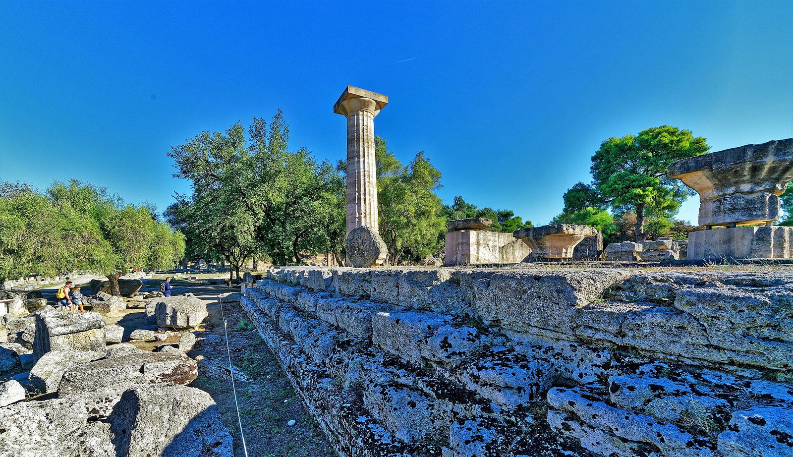 A single standing column of the Temple of Zeus at Olympia among fallen drums