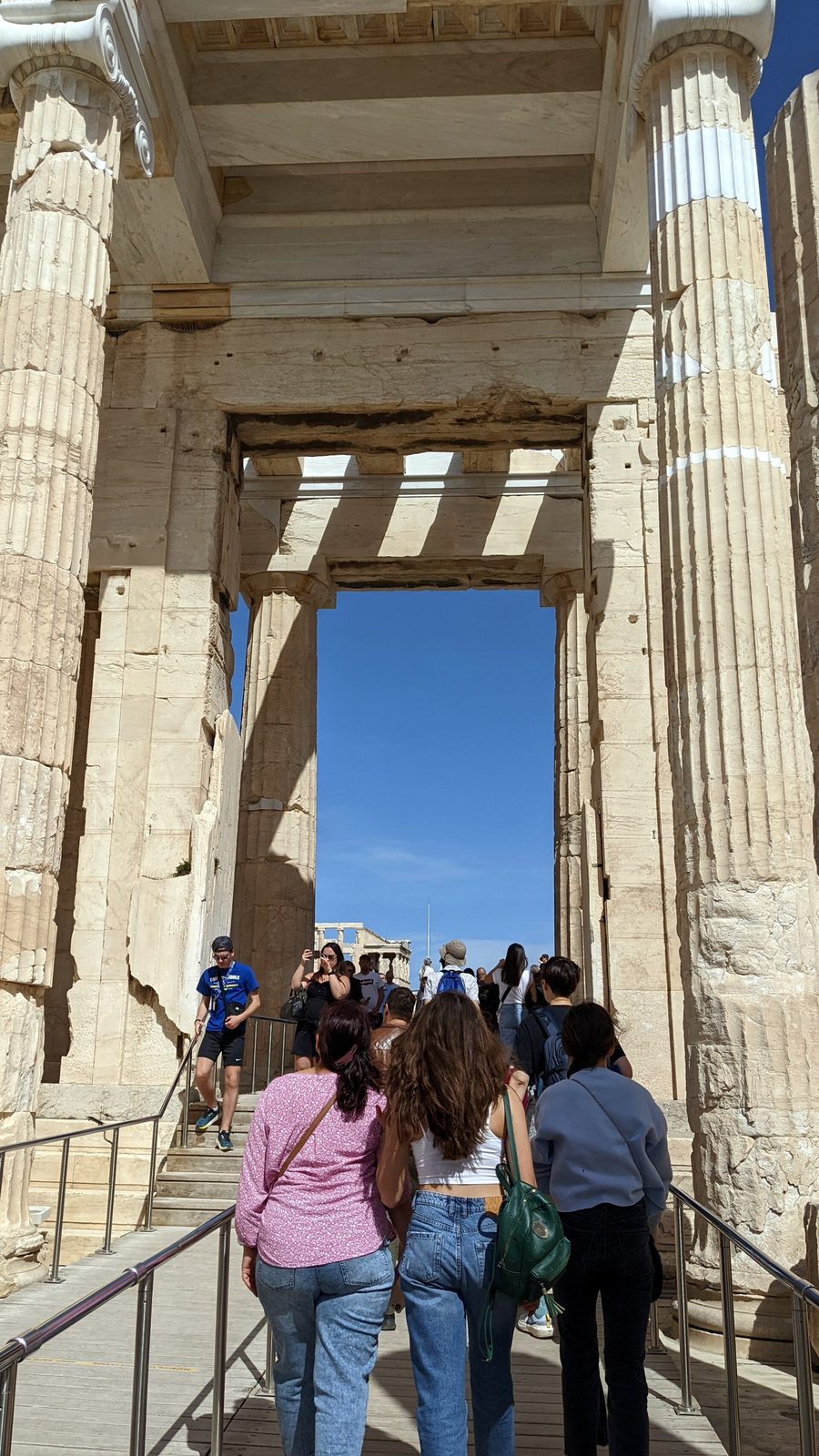 Walking through the Propylaia, the monumental gateway of the Acropolis