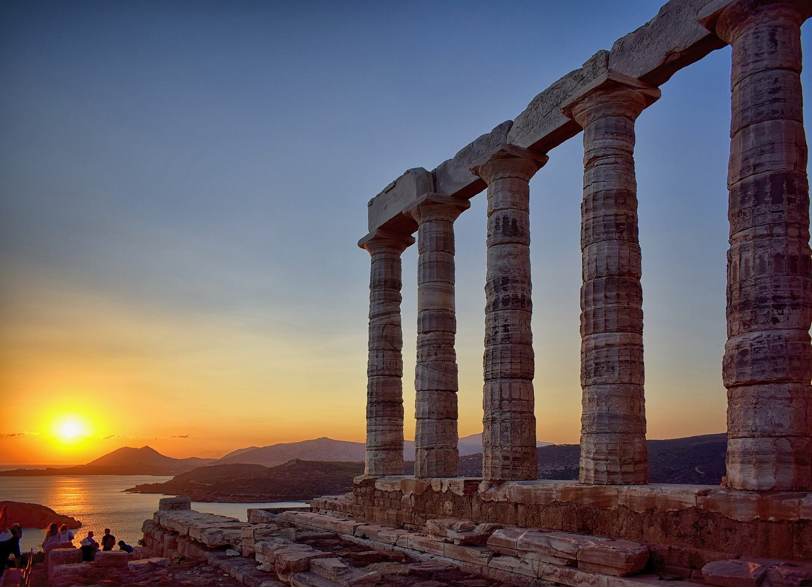 The Temple of Poseidon at Cape Sounion at sunset above the Aegean