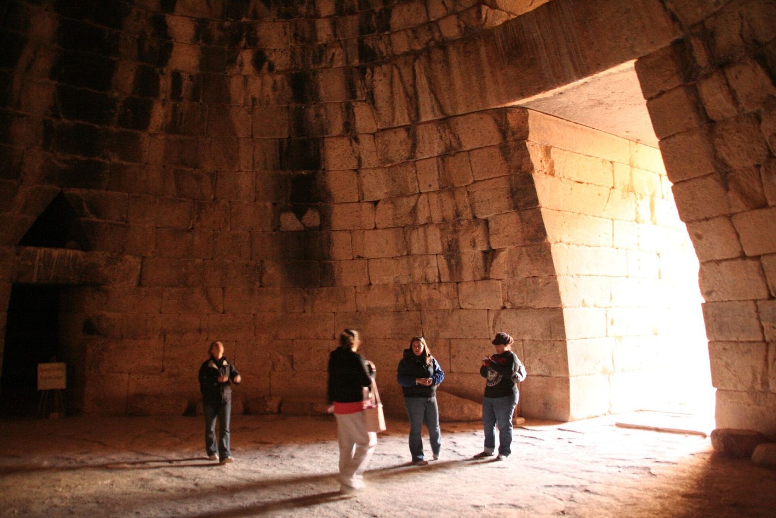 Inside the Treasury of Atreus at Mycenae: the corbelled tholos dome lit from the doorway