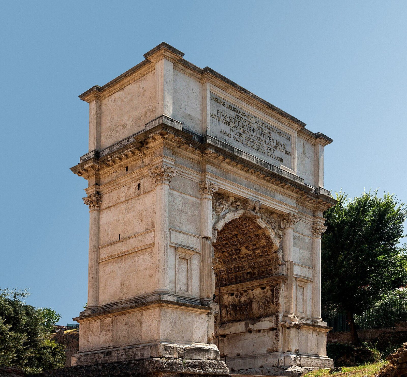 The Arch of Titus in the Roman Forum seen from the side: the single marble archway, its relief panels visible inside the vault and the inscribed attic above