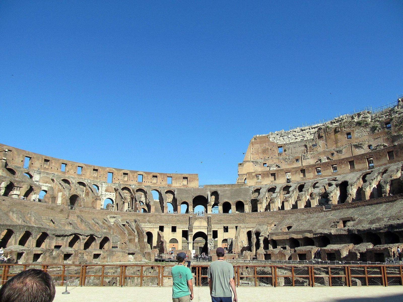 Inside the Colosseum: the arena floor area and the exposed walls of the hypogeum below, ringed by the rising tiers of the cavea