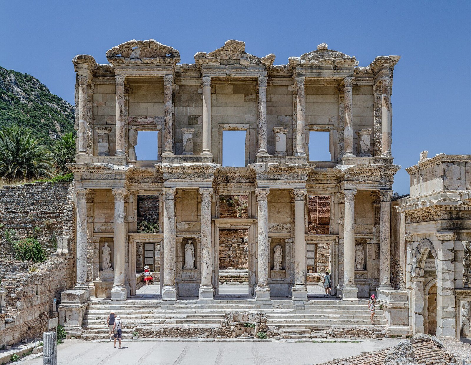 The reconstructed marble facade of the Library of Celsus at Ephesus: two storeys of columns framing statues in niches and tall doorways