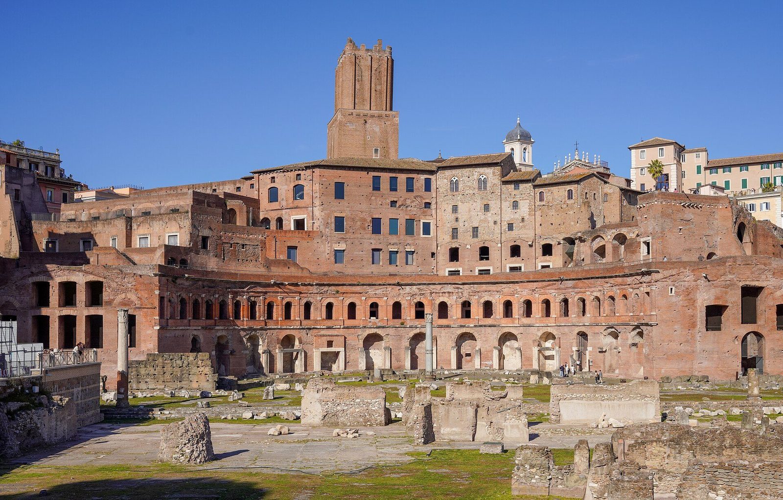 Trajan's Markets in Rome: the great curved brick facade of the ancient shopping complex, with the medieval Torre delle Milizie rising behind it