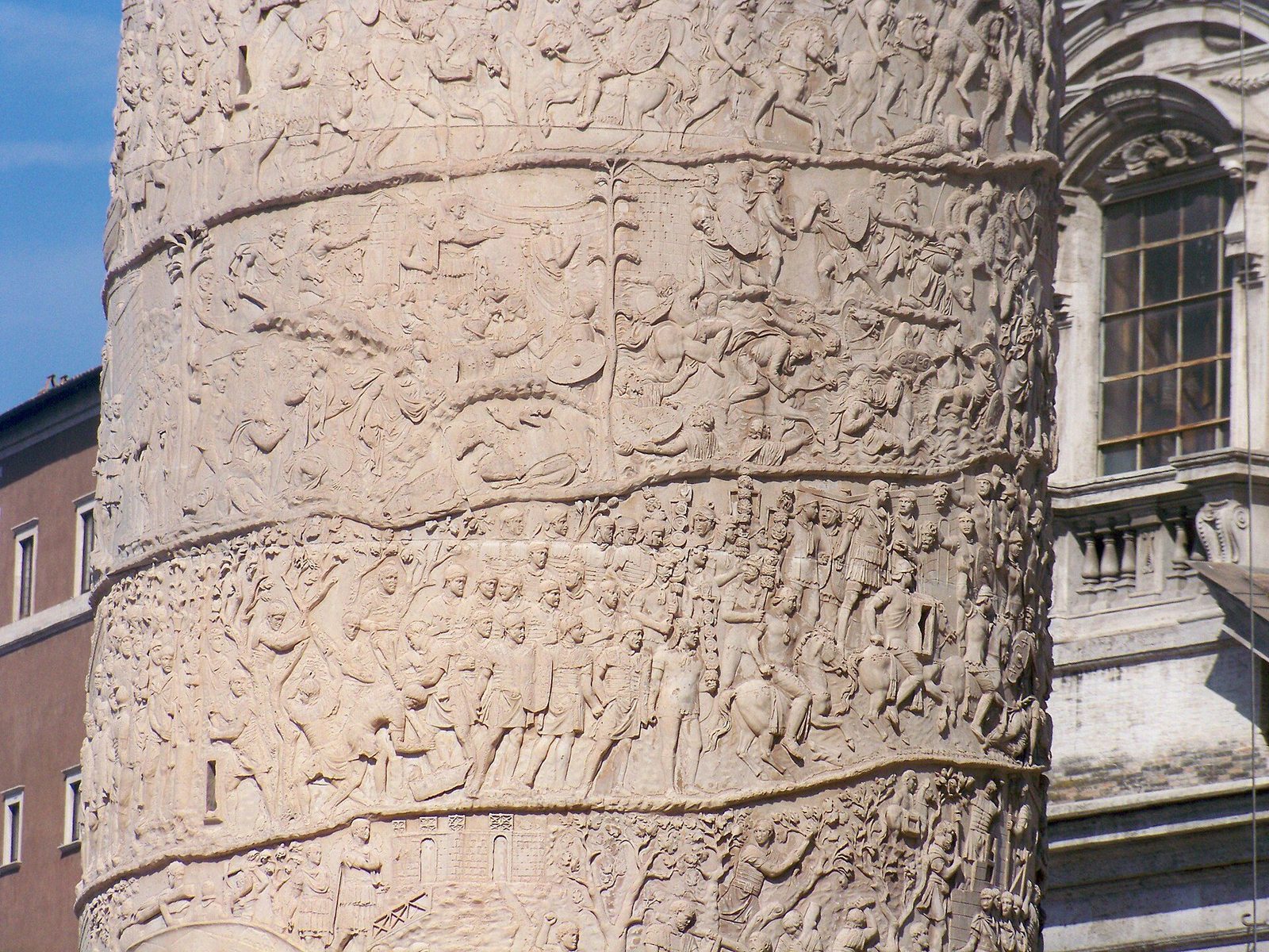 Detail of Trajan's Column in Rome: two bands of the spiral relief crowded with carved Roman soldiers, horses and standards